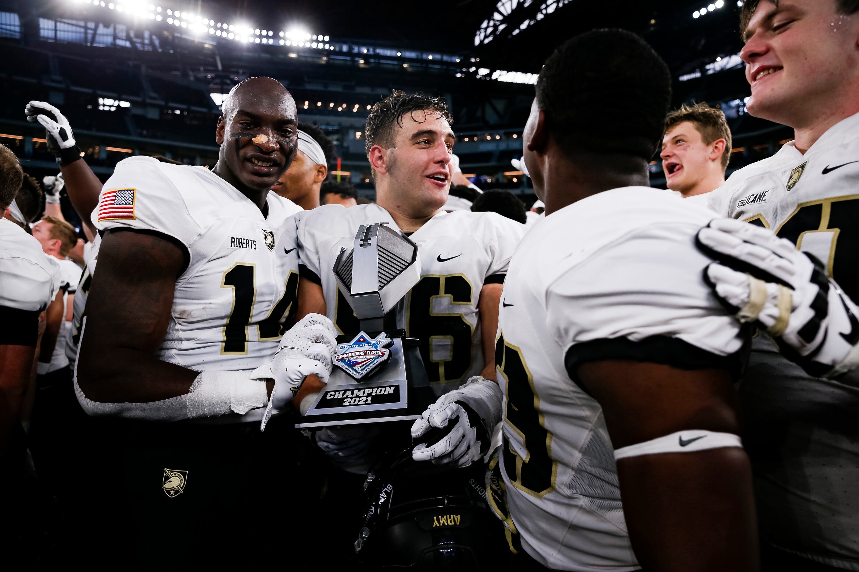 Army Black Knights hold the trophy after winning during overtime of the 2021 Lockheed Martin...