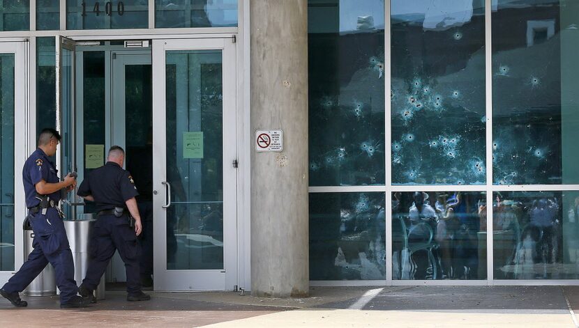 Bullet holes pierced the side of the Dallas police headquarters after James Boulware opened...