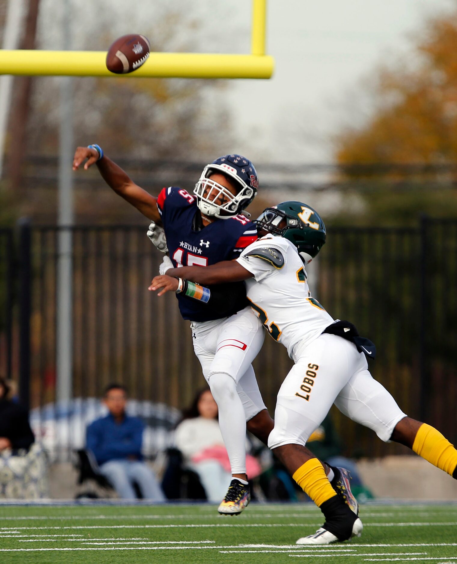 Denton Ryan QB Khalon Davis (15) is hit while releasing a pass by Longview defender Kaden...