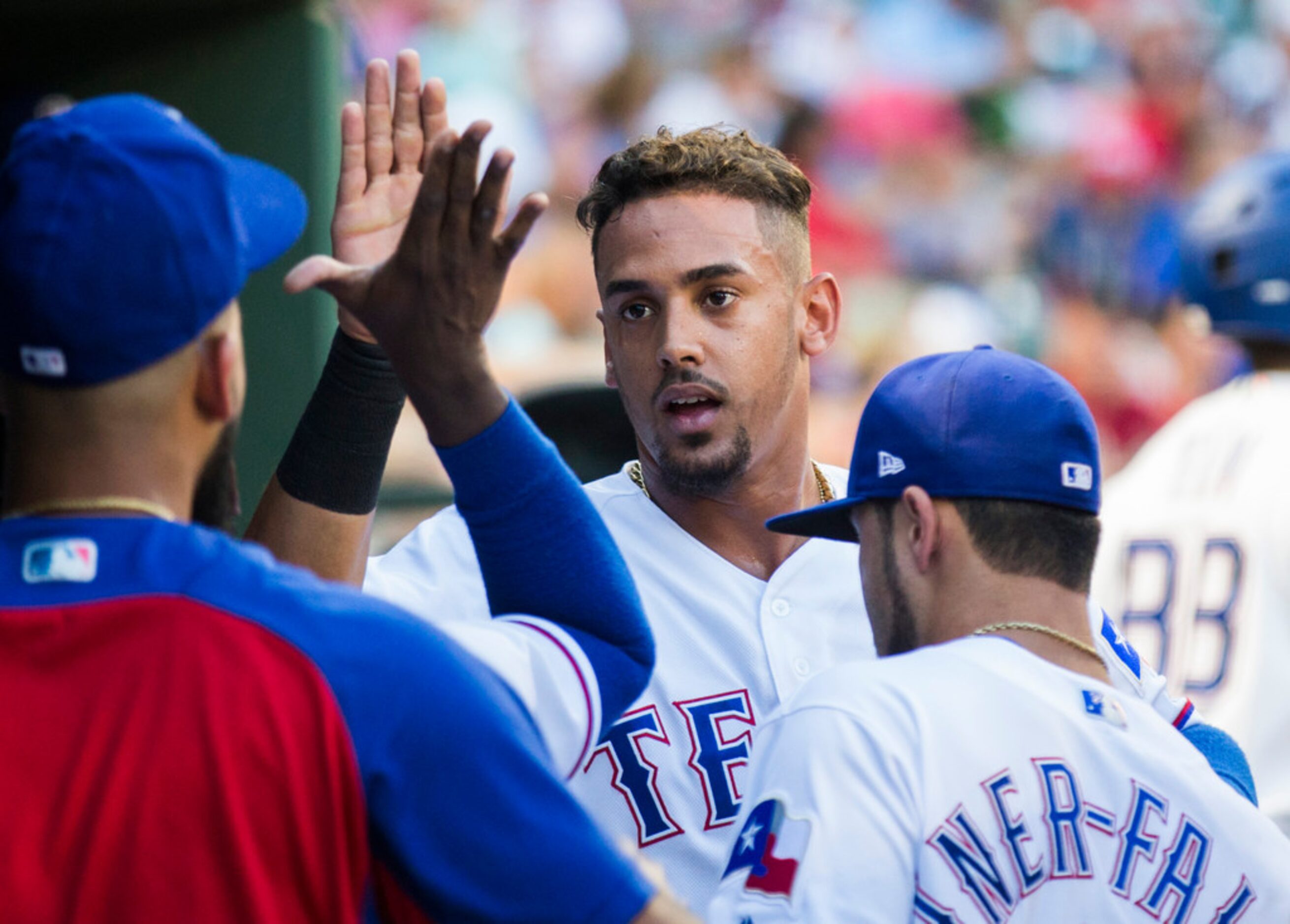 Texas Rangers first baseman Ronald Guzman (67) gets a high-five in the dugout during an MLB...