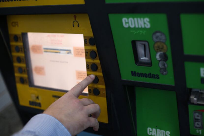 A customer uses a DART ticket machine at Union Station.