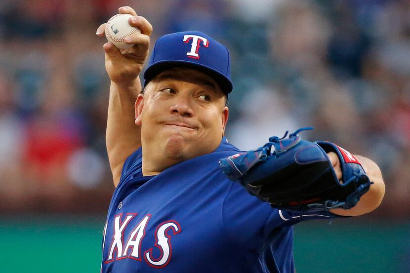 Texas Rangers starting pitcher Bartolo Colon (40) throws a first-inning pitch during the New...