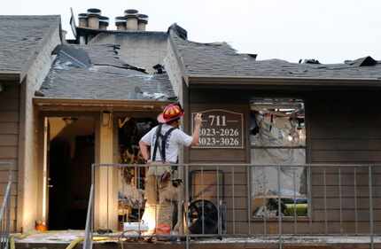 An Arlington firefighter inspected damage at the Trails at River Park Apartments last year....