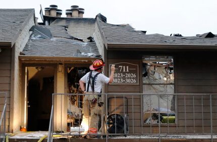 An Arlington firefighter inspected damage at the Trails at River Park Apartments last year....