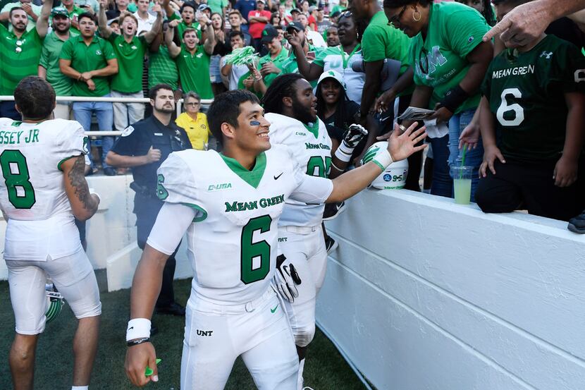 North Texas quarterback Mason Fine celebrates with fans after defeating Arkansas 44-17 after...