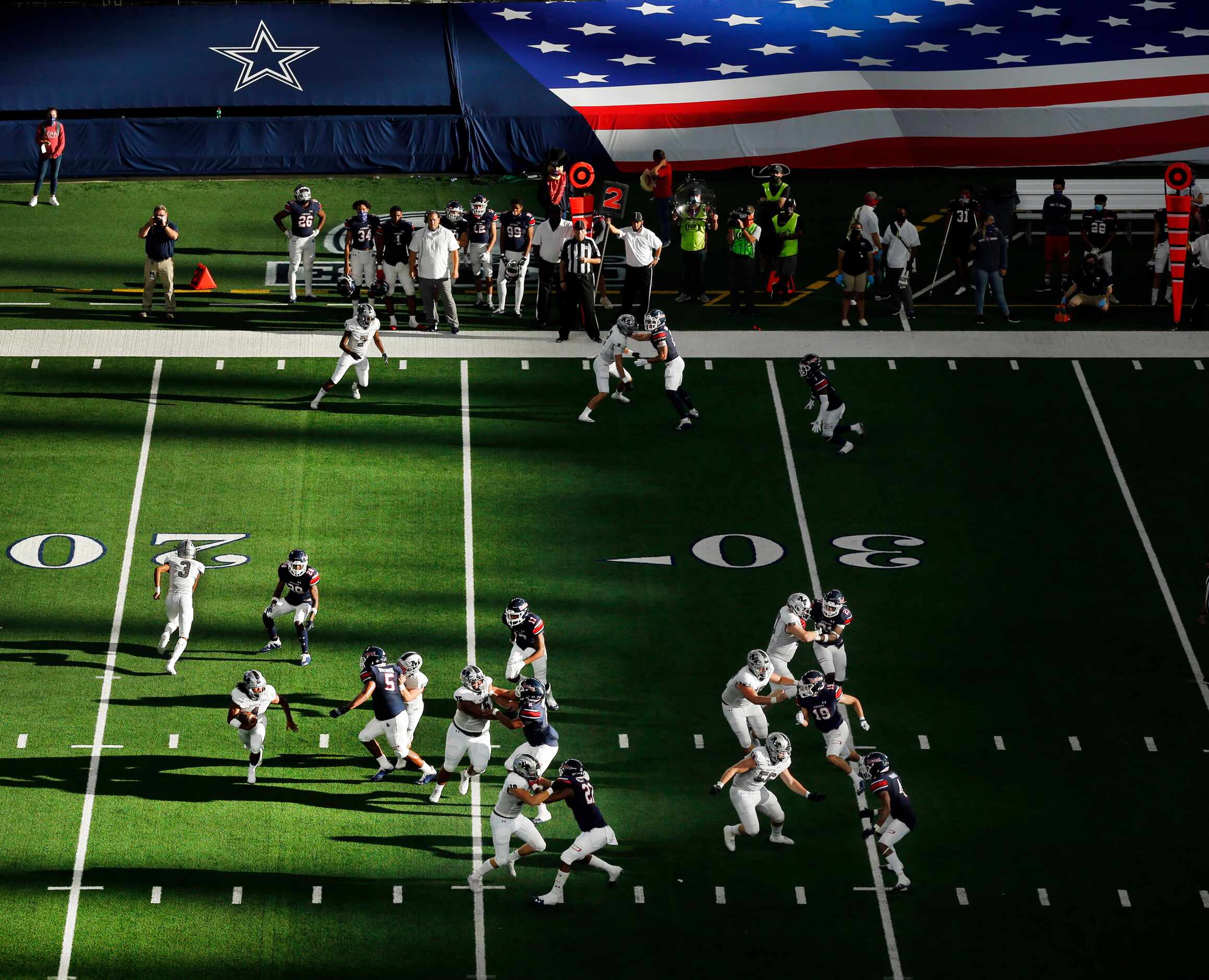 With sunshine streaming across the field, Arlington Martin's running back Zaire Barrow (4)...