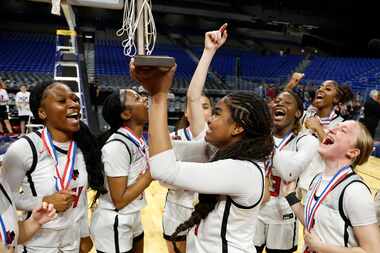Frisco Liberty's Keyera Roseby (5) lifts the trophy after winning the UIL Class 5A state...