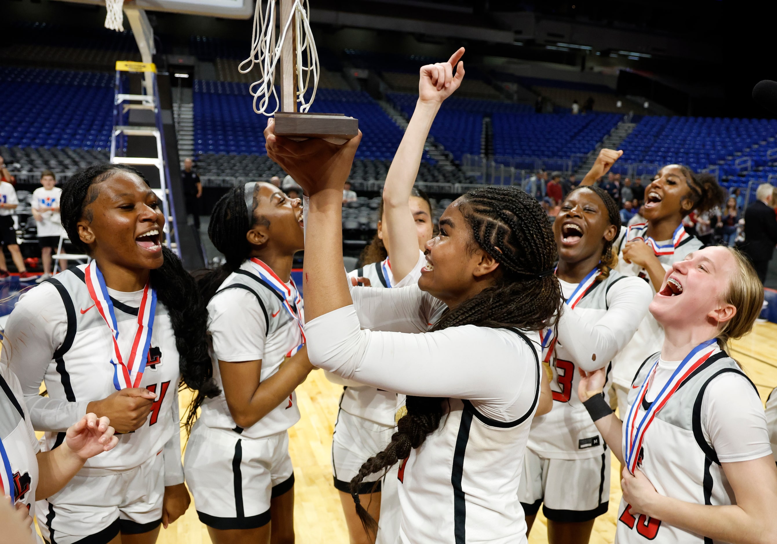 Frisco Liberty's Keyera Roseby (5) lifts the trophy after winning the UIL Class 5A state...