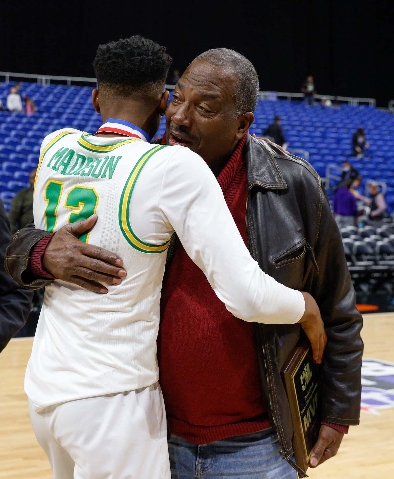 Madison forward Rodney Geter (13) hugs State Sen. Royce West as he accepts the MVP trophy...