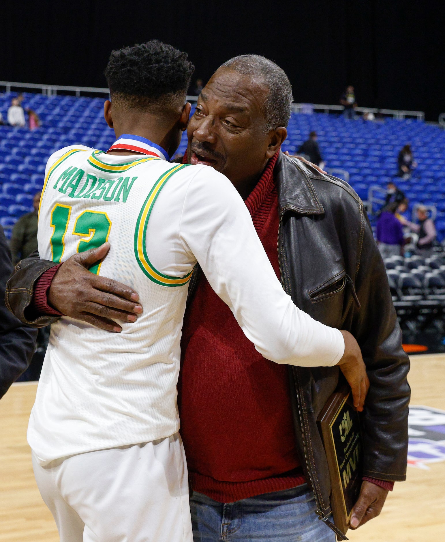 Madison forward Rodney Geter (13) hugs State Sen. Royce West as he accepts the MVP trophy...