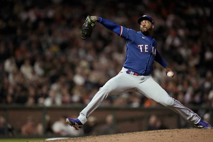 Texas Rangers pitcher Aroldis Chapman throws to a San Francisco Giants batter during the...