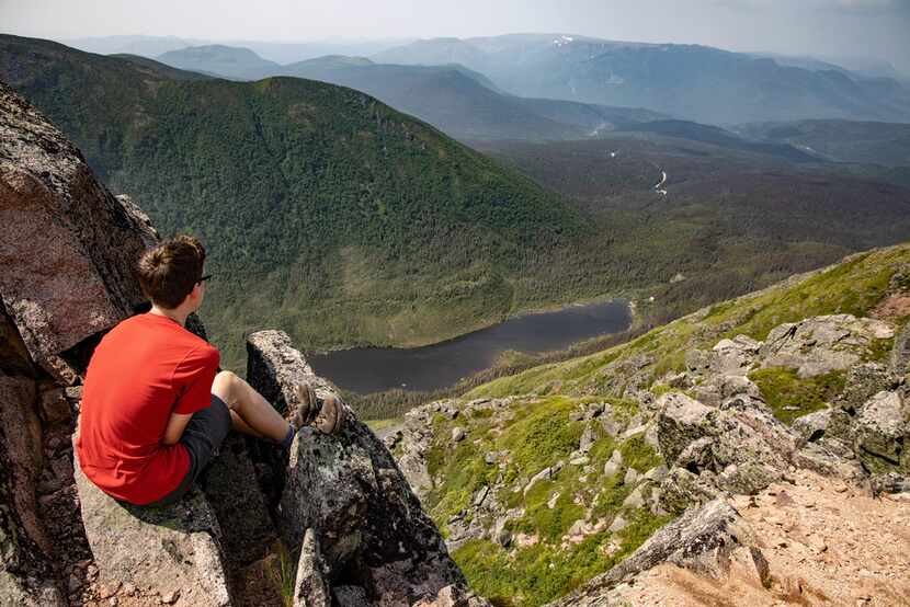 Andy Irwin, 14, peers down from the summit of Mont Xalibu.