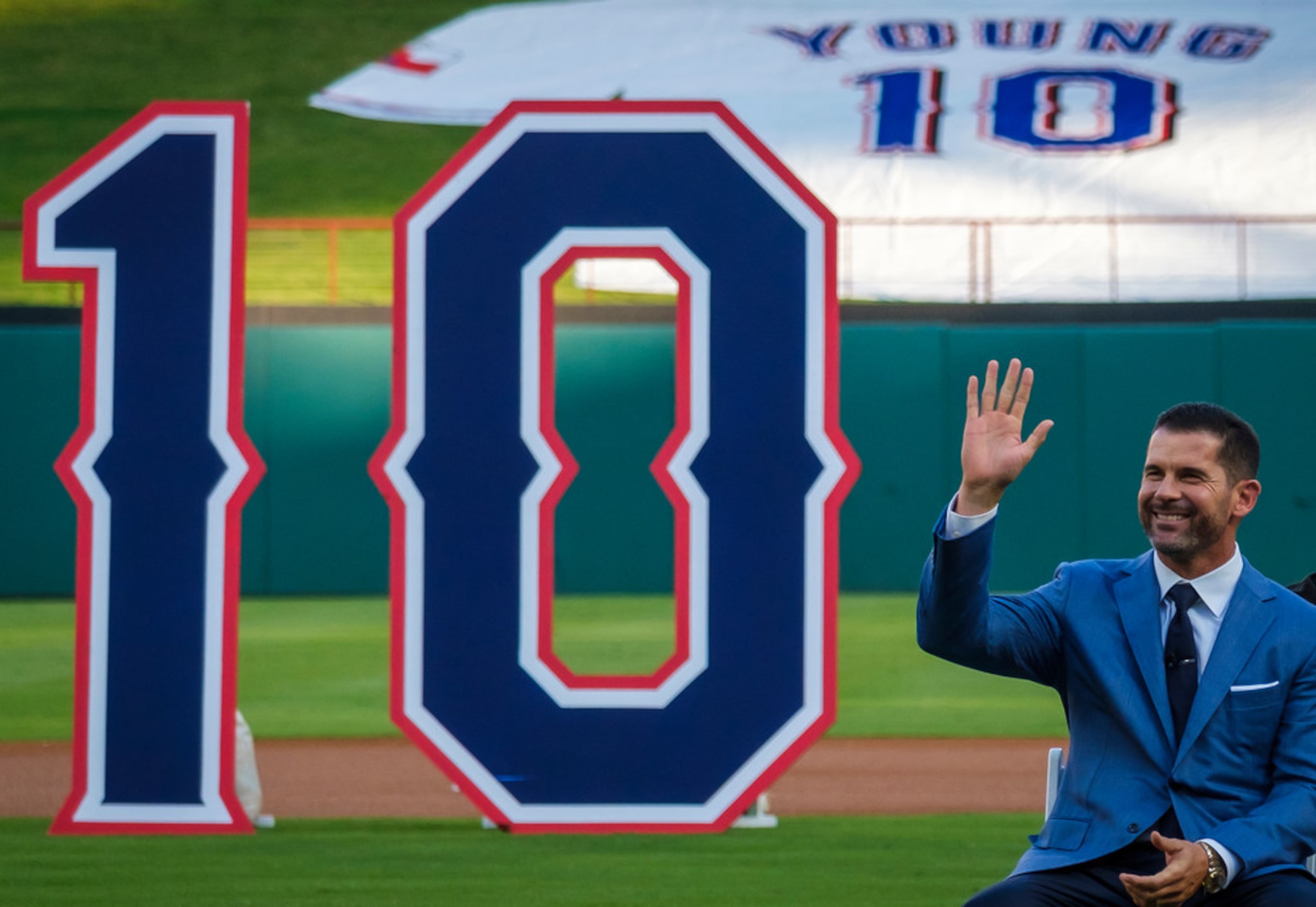 Michael Young waves to the crowd during ceremonies to retire Young's No. 10 before a game...