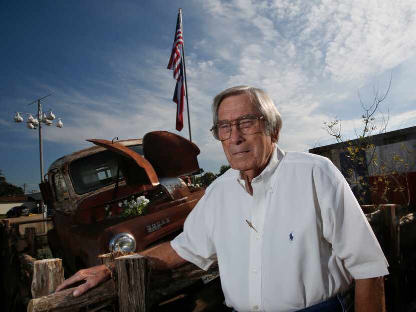 Joe Mapes, owner of Joan's Spot Free Car Wash, stands by a 1950 Dodge pickup truck in front...