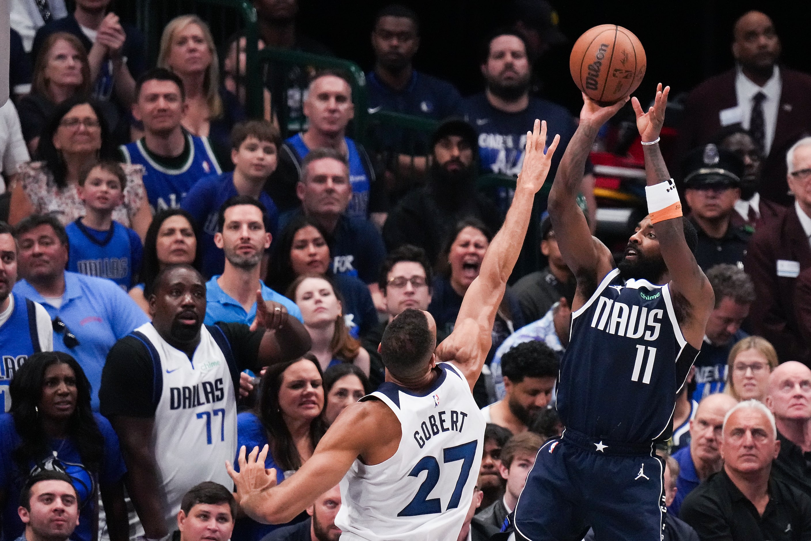 Dallas Mavericks guard Kyrie Irving (11) shoots over Minnesota Timberwolves center Rudy...