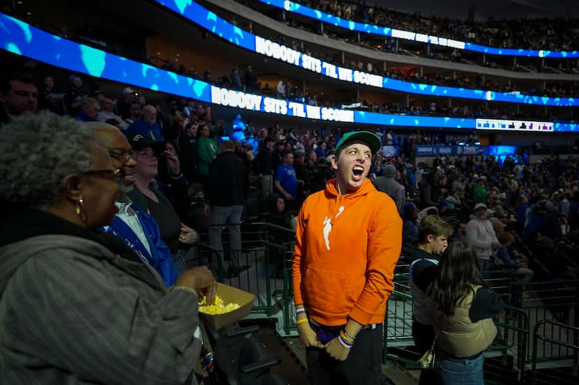 Baxter Berle, a Dallas Mavericks fan in section 109, cheers the team during introduction...
