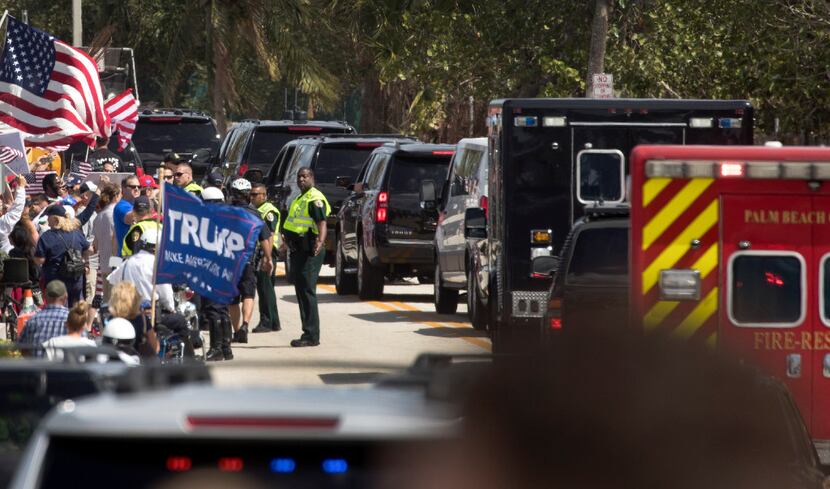 President Donald Trump's motorcade rolls past supporters near his Mar-a-Lago resort in Palm...