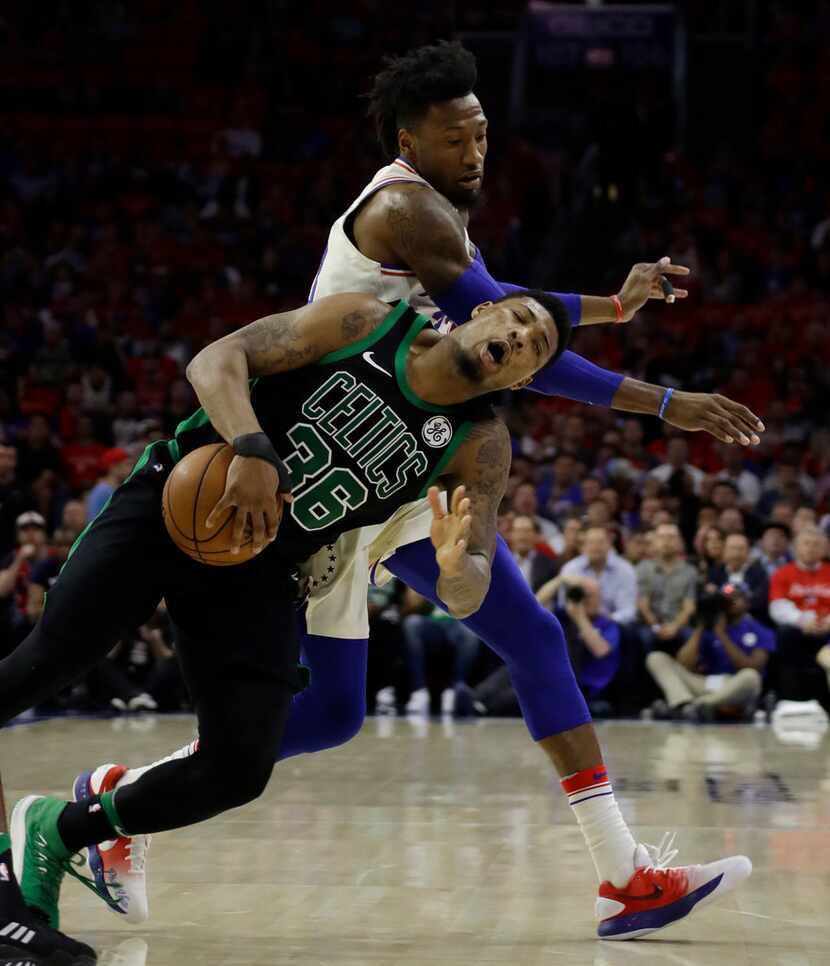 Boston Celtics' Marcus Smart, left, and Philadelphia 76ers' Robert Covington collide chasing...