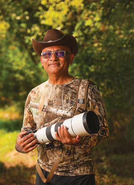 Rajiv Roy, the photographer, holding his camera wide-angle lens