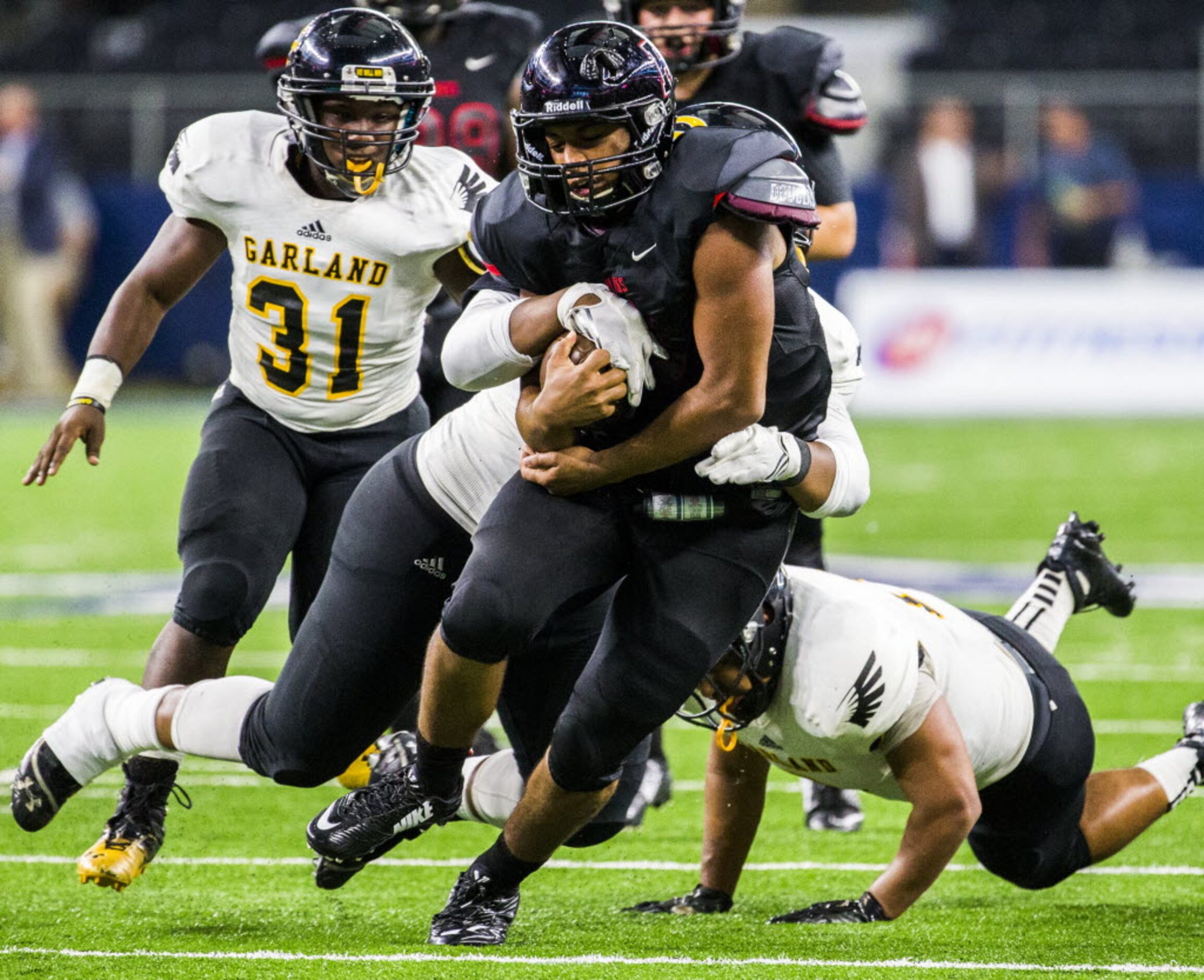 Garland defensive end Jalen Reynolds (44) and Garland linebacker Perry Overton (2) tackle...