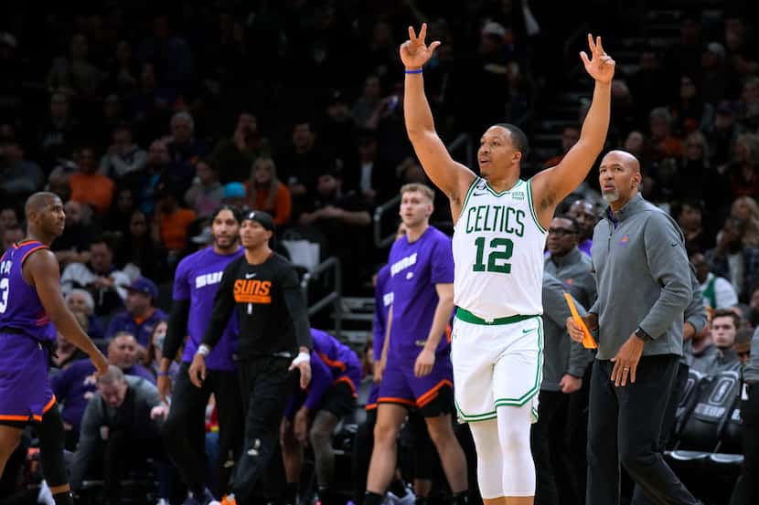Boston Celtics forward Grant Williams (12) reacts in front of the Phoenix Suns bench after...