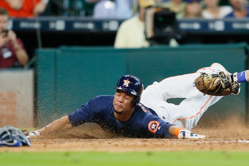 HOUSTON, TX - AUGUST 07:  Carlos Gomez #30 of the Houston Astros slides around the tag...