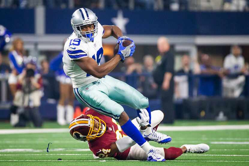 Dallas Cowboys wide receiver Amari Cooper (19) is tripped up by Washington Redskins...