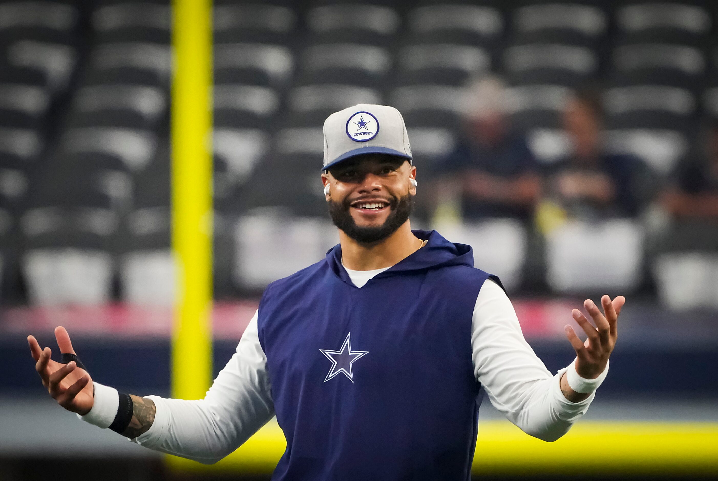 Dallas Cowboys quarterback Dak Prescott warms up before an NFL football game against the...