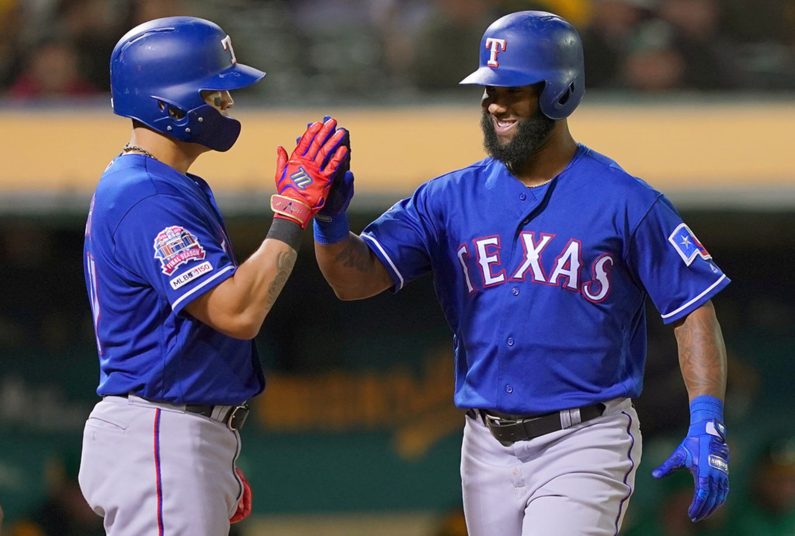 OAKLAND, CA - JULY 25:  Danny Santana #38 of the Texas Rangers is congratulated by Shin-Soo...