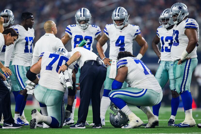 Dallas Cowboys offensive guard Zack Martin (70) is checked out after an injury during the...