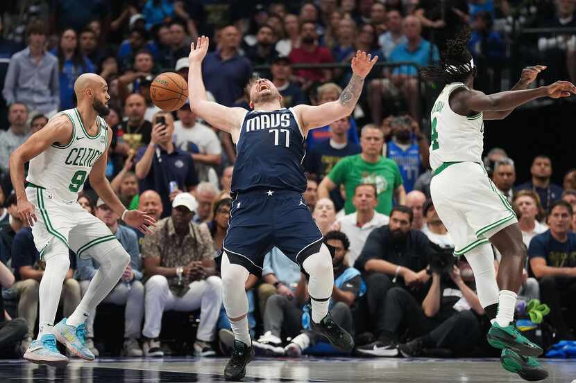 Dallas Mavericks guard Luka Doncic (77) loses the ball as Boston Celtics guard Derrick White...
