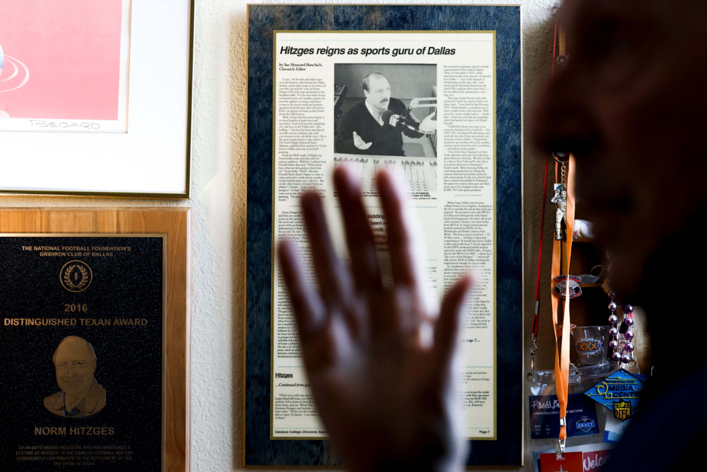 Memorabilia hangs on the wall of local sports radio legend 
Norm Hitzges’ office at his home...