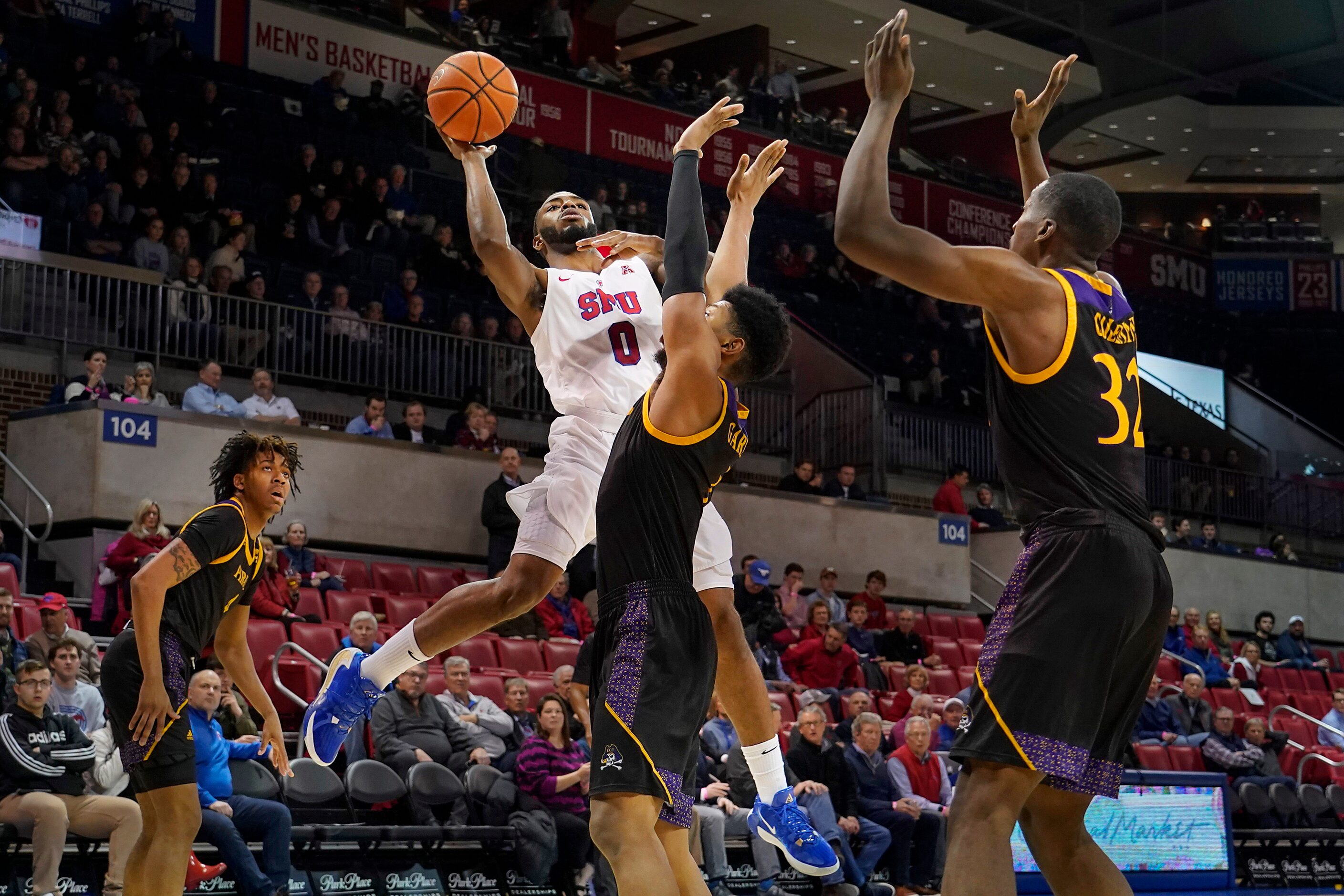 SMU guard Tyson Jolly (0) shoots over East Carolina forward Jayden Gardner (1) during the...