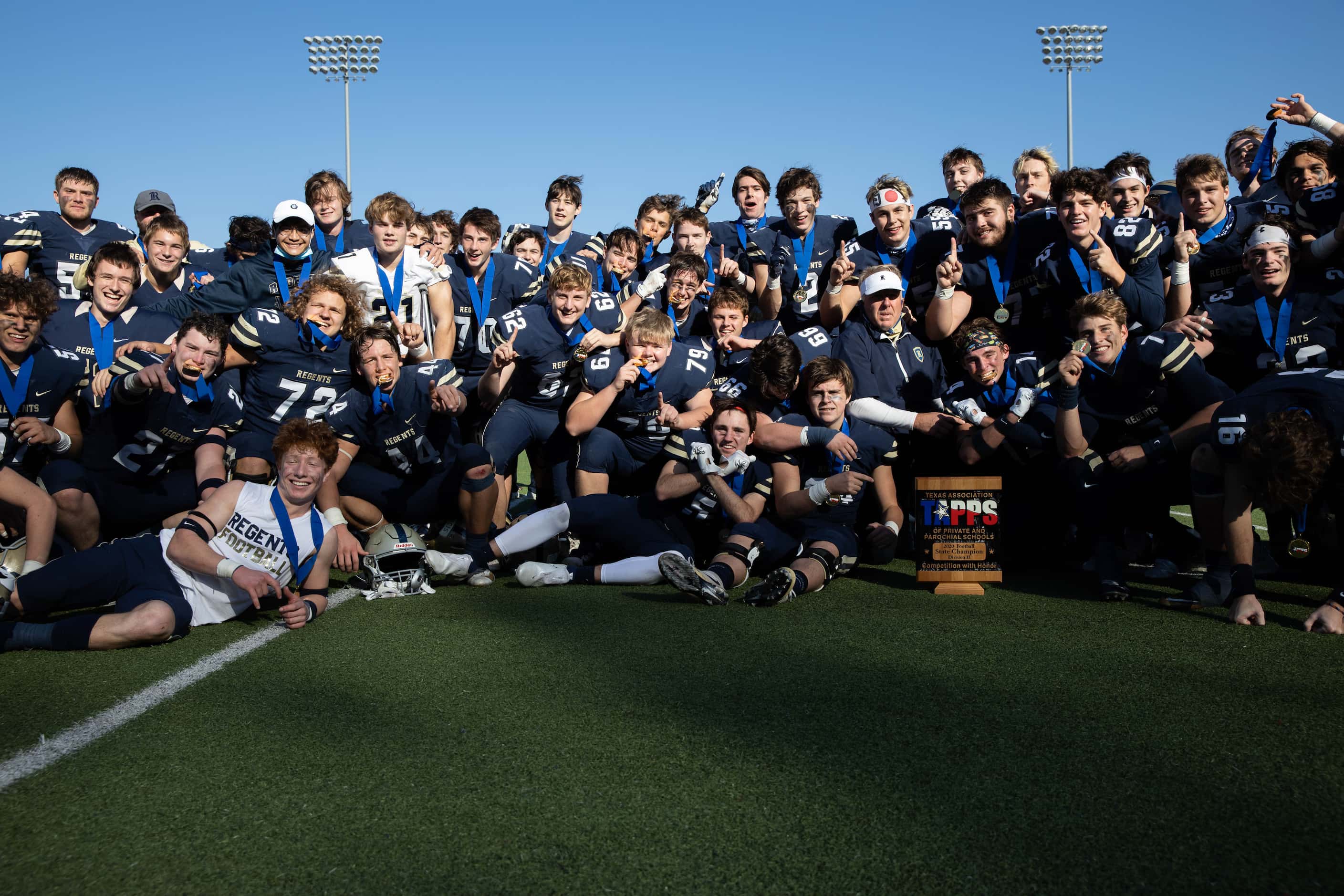 Austin Regents players pose for a photo after winning a TAPPS Division II state championship...