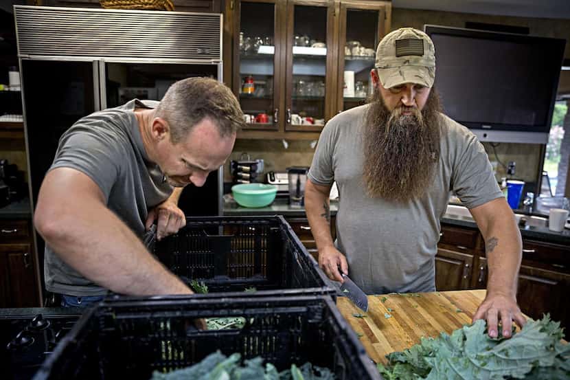Stephen Smith  (left) and James Jeffers grow kale and other produce on a farm in DeSoto....