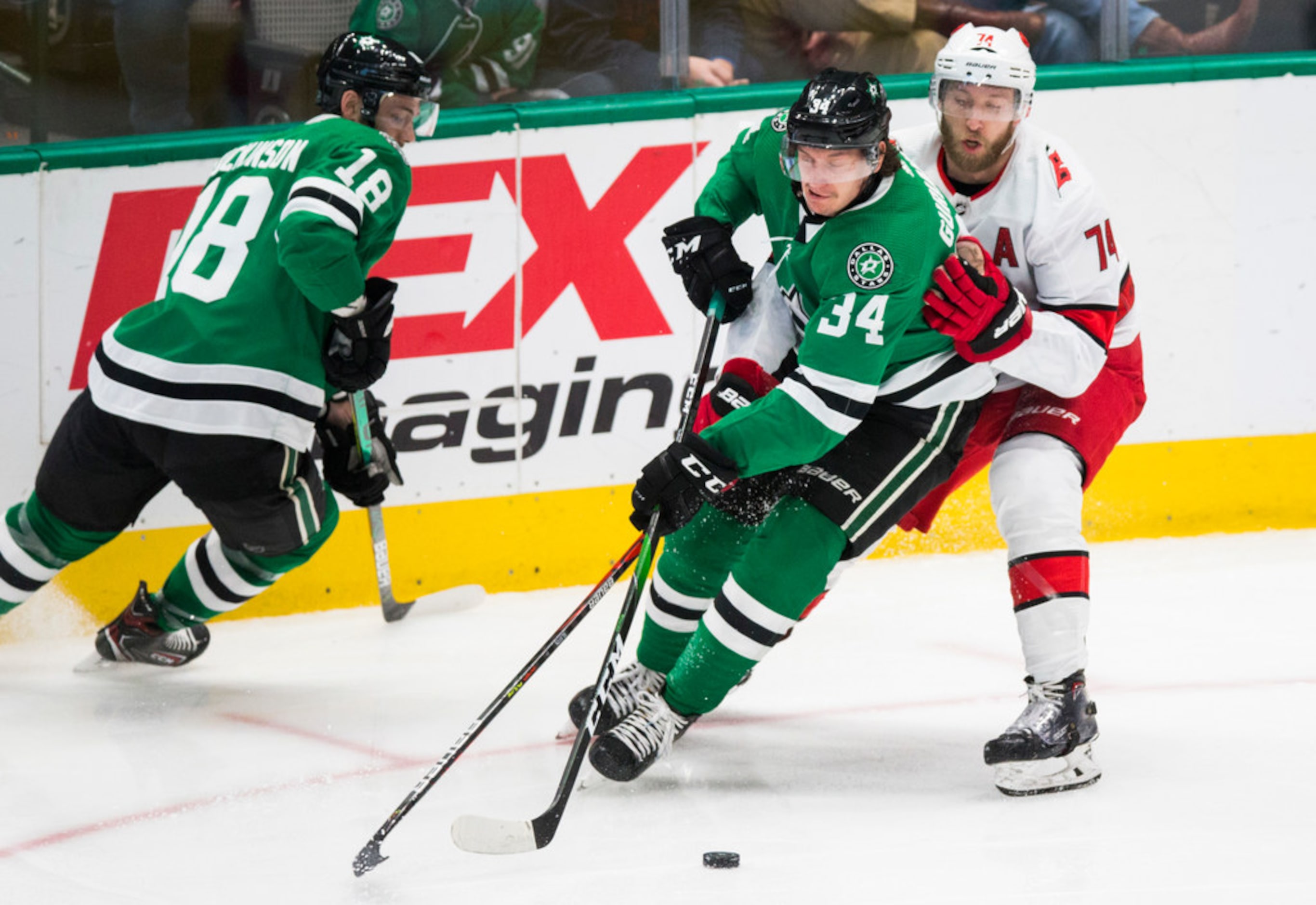 Dallas Stars right wing Denis Gurianov (34) tries to remain in control of the puck with...