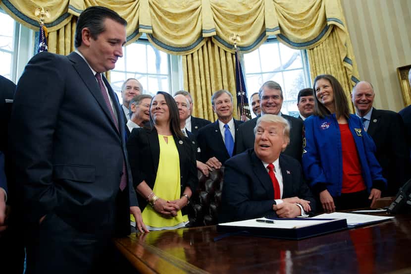 President Donald Trump jokes with Sen. Ted Cruz, R-Texas, during a signing ceremony in the...