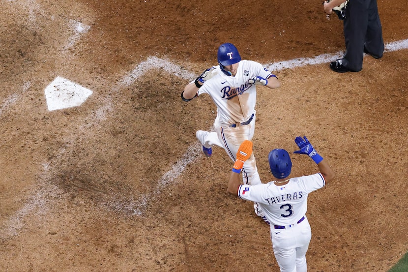 Texas Rangers' Corey Seager celebrates with Leody Taveras after hitting a two-run home run...