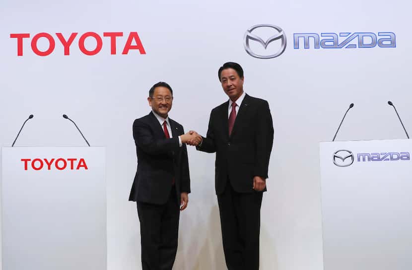 Toyota President Akio Toyoda (left) and Mazda President Masamichi Kogai