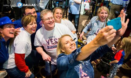 Andrea Proctor takes a selfie as supporters of a new stadium for the Rangers celebrate after...