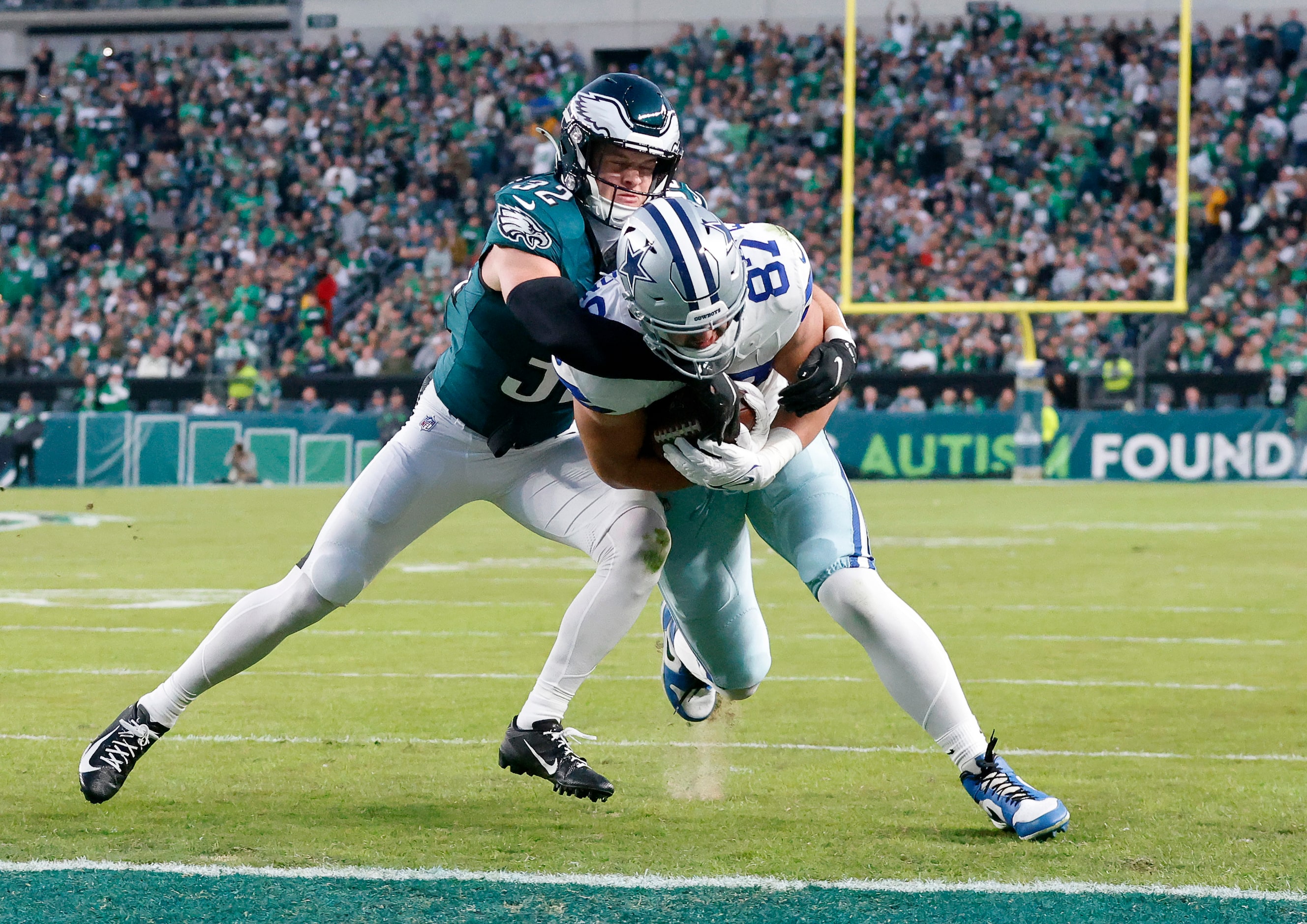 Dallas Cowboys tight end Jake Ferguson (87) scores a first quarter touchdown as he’s tackled...