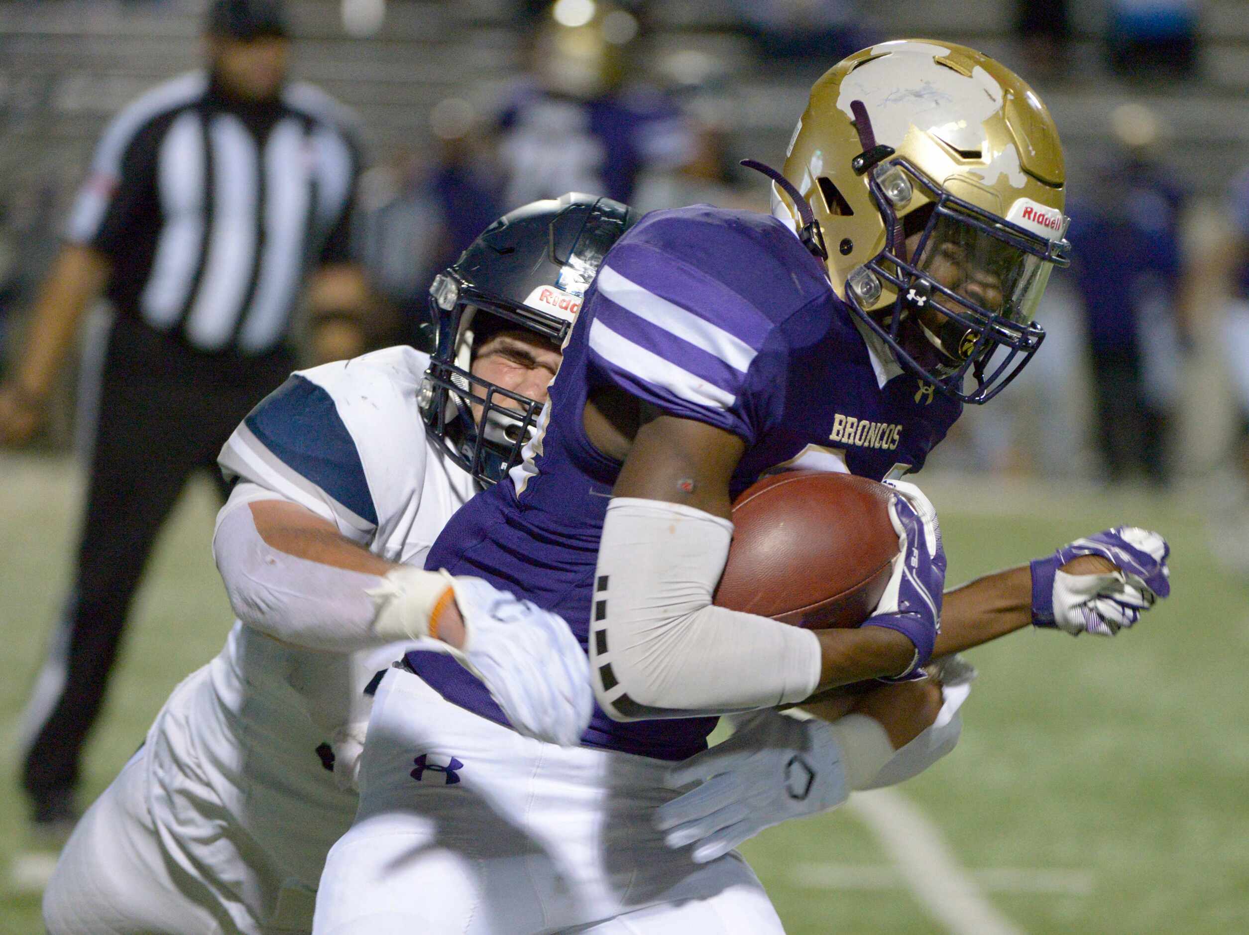Denton’s Coco Brown (34) is tackled by Lone Star’s Alessio Russolillo in the second quarter...