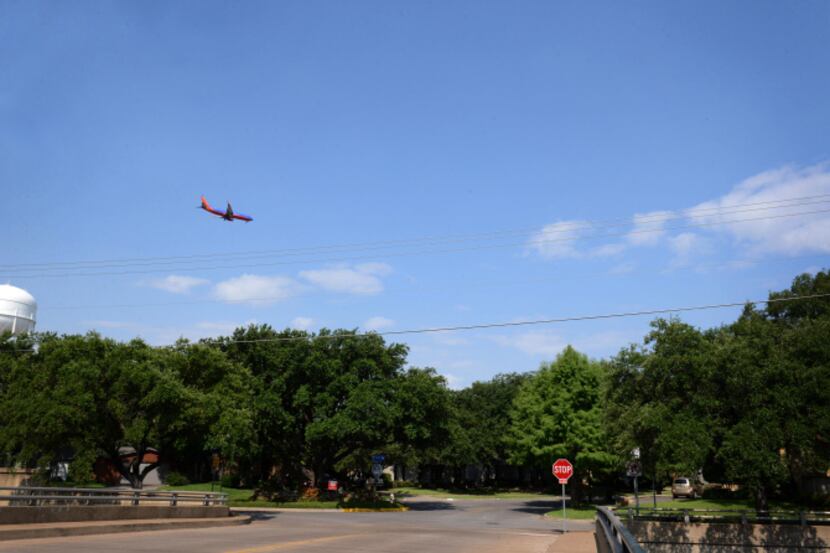 Seen from the Highland Park Neighborhood, a plane comes in for a landing on the Lemmon...