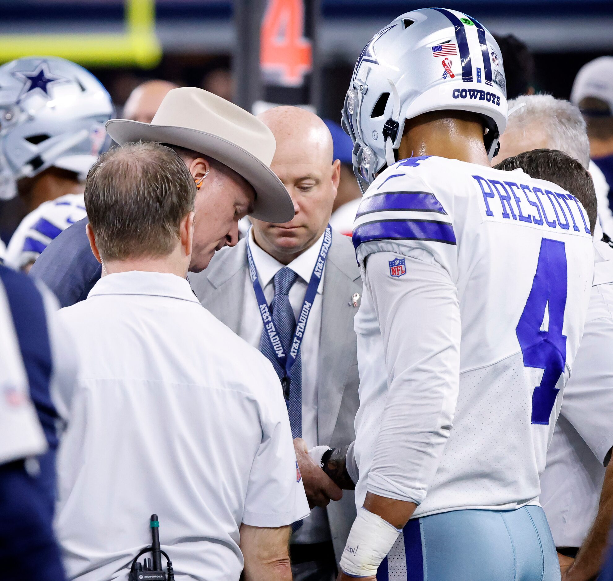 Dallas Cowboys quarterback Dak Prescott (4) has his throwing hand looked at by team...