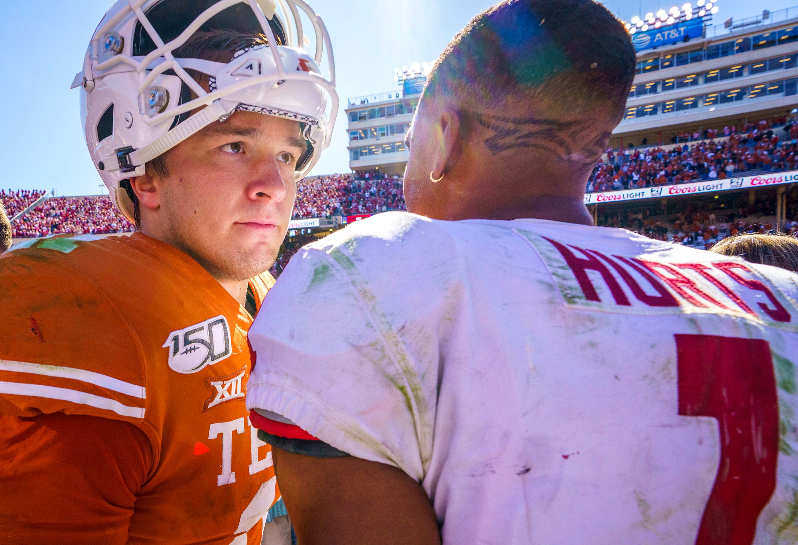 Texas quarterback Sam Ehlinger (11) hugs Oklahoma quarterback Jalen Hurts (1) after the...