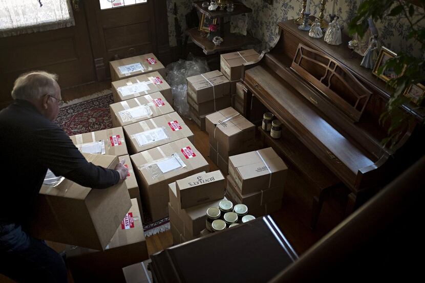 

Harold Green stacks boxes filled with Bentley’s Batch 5 barbecue sauce in the foyer of his...