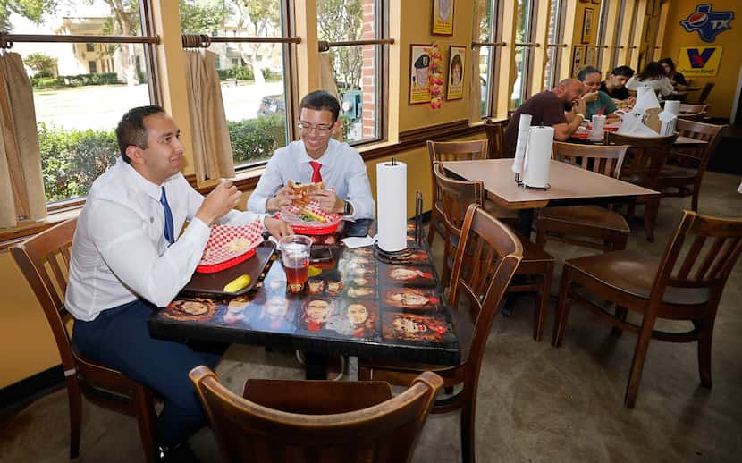 Cesar Gonzalez, left, and Gerald Aquino, both from Irving, have sandwiches at Weinberger's...