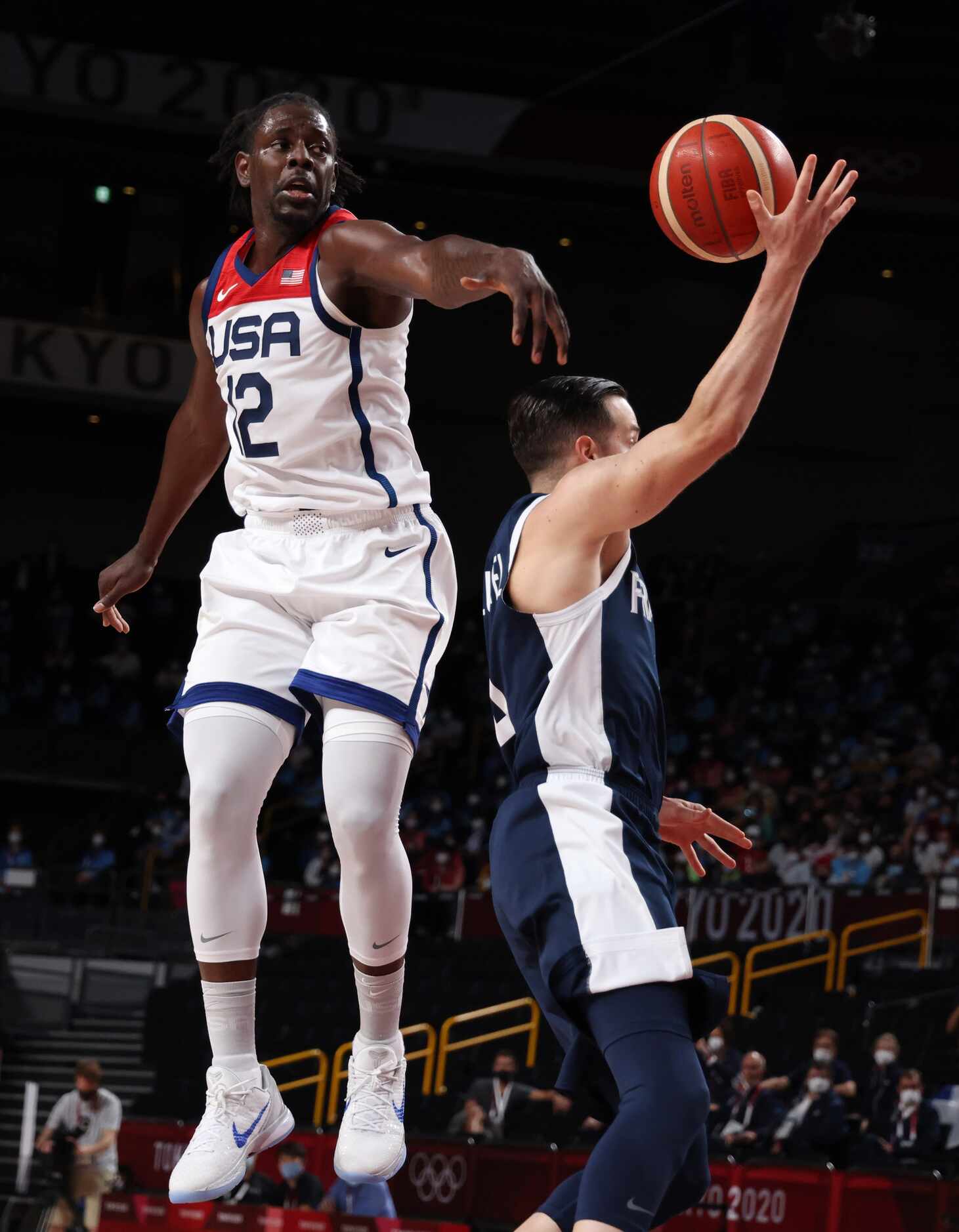 USA’s Jrue Holiday (12) swipes the ball away from France’s Thomas Heurtel (4) during the...