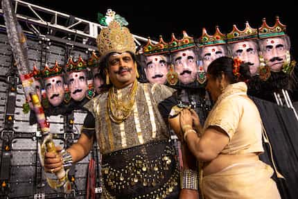 Mangala Kagal helps Dr. Prakash Kagal straighten his Ravana costume, a 10-headed demon...