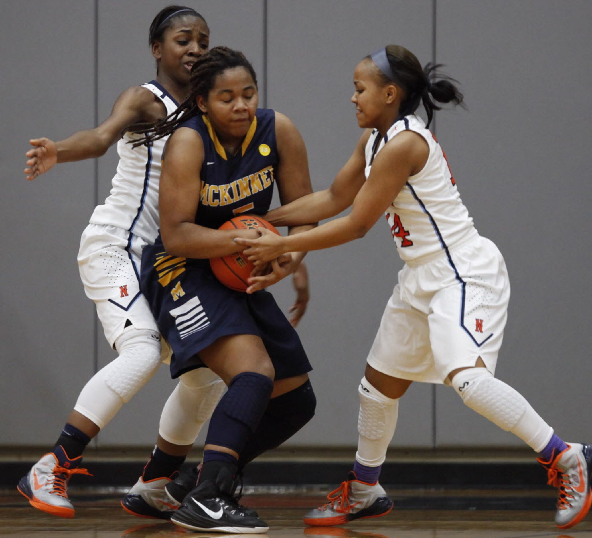 McKinney guard Kayla Moutry (5) tries to keep possession of the basketball as she is...